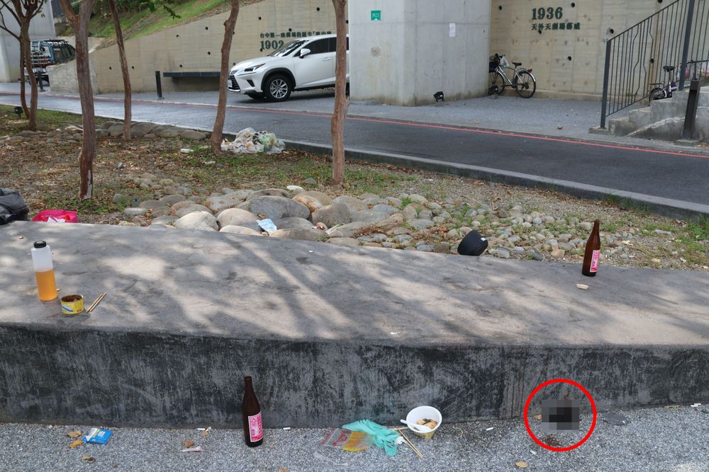 一坨完整的人類糞便(紅圈處）已被烈陽曬到發黑外相當惡臭。張喆喜攝