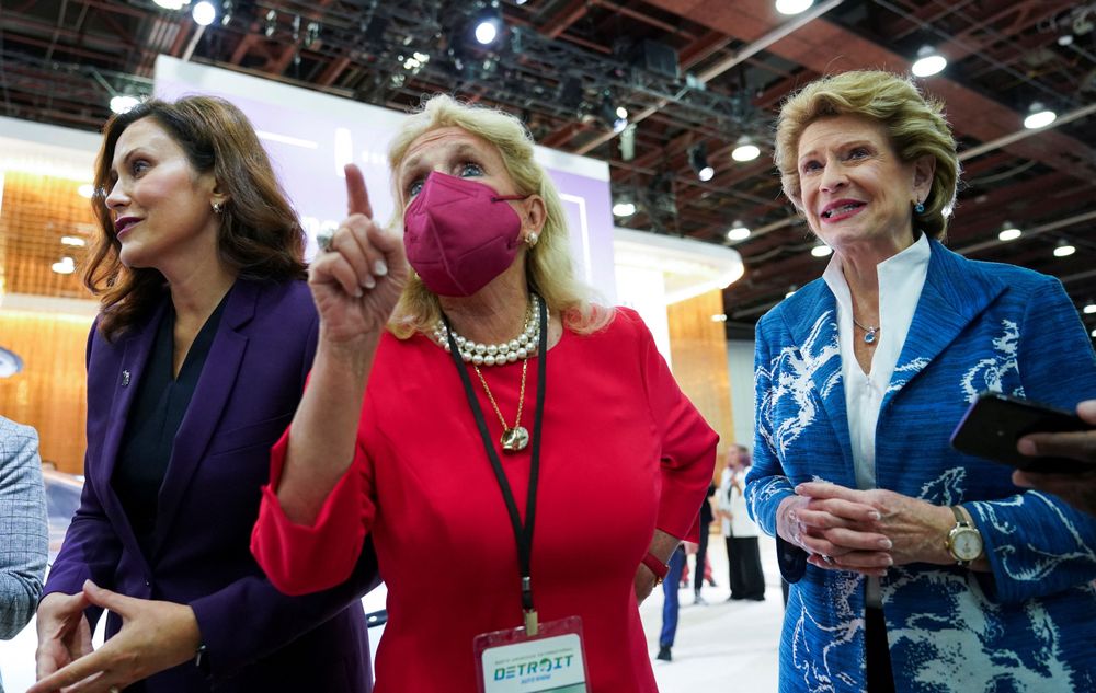 密西根州聯邦眾議員丁格爾（中）一頭金色中長大波浪捲髮，逛車展當天戴著著口罩，許多人誤以為她是總統夫人吉兒拜登。左為密西根州州長惠特梅爾，右為民主黨籍密西根州參議員斯塔貝諾（Debbie Stabenow）。美聯社