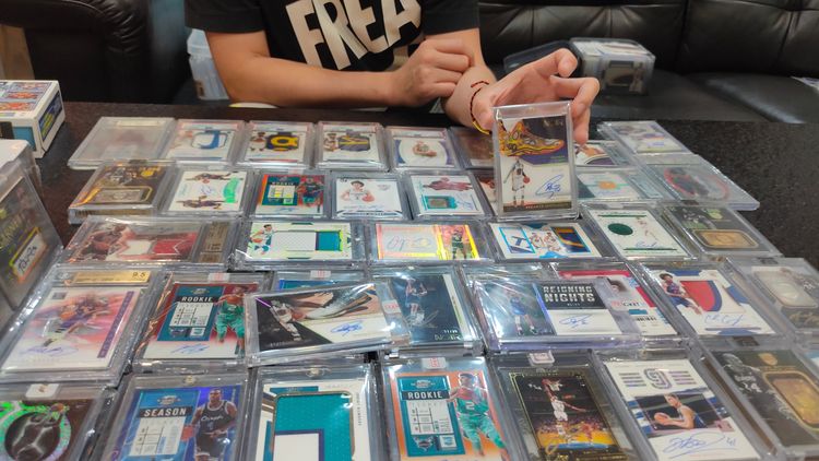 彭先生手上的球員卡為勇士隊球星柯瑞。鮮明攝