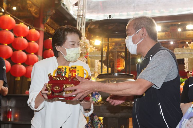 黃珊珊（左）獲廟方贈與杯子。翁玉信攝