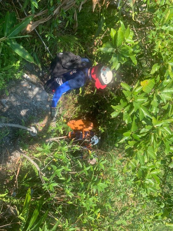 當地地勢險峻，搜救人員冒險下切救援。讀者提供