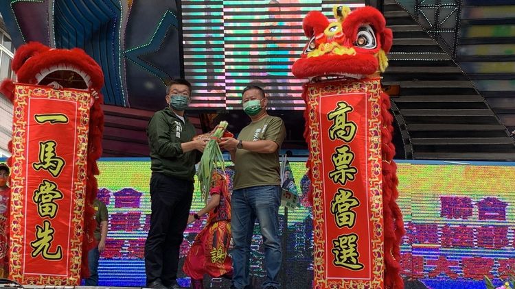 蔡其昌送上象徵「凍蒜」的青蒜給市議員李天生，預祝兩人都能在年底選戰高票「凍蒜！」曾雪蒨攝