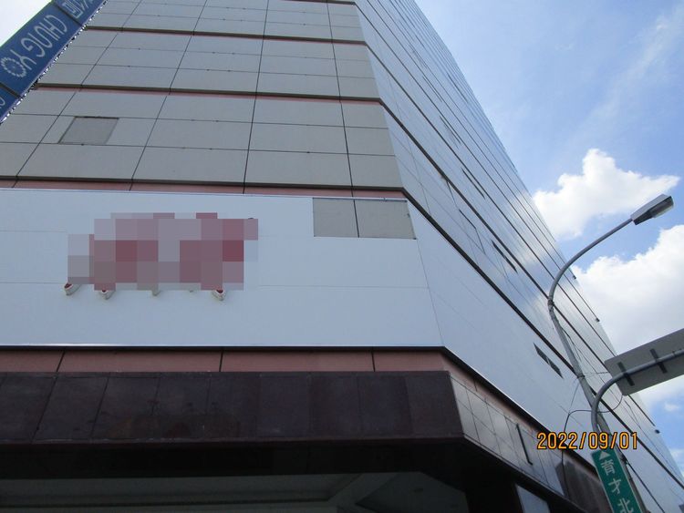 百貨公司外牆的廣告物被吹落。讀者提供