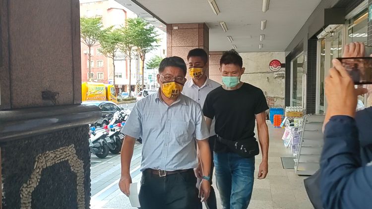 黃男(右)在立委邱顯智(左)陪同下到派出所領取通知書。黃子騰攝