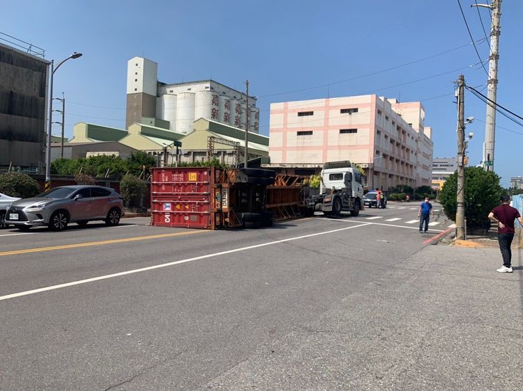 貨櫃翻覆佔據車道，曳引車幸好未受到牽連。讀者提供