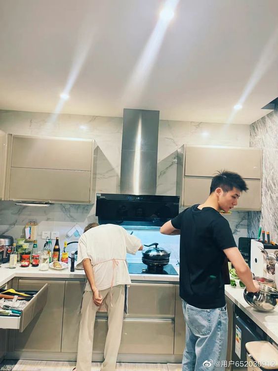 周揚青日前邀好友夫婦到家中聚會，拍下好友老公（右）和1名神秘男子做菜。翻攝周揚青微博
