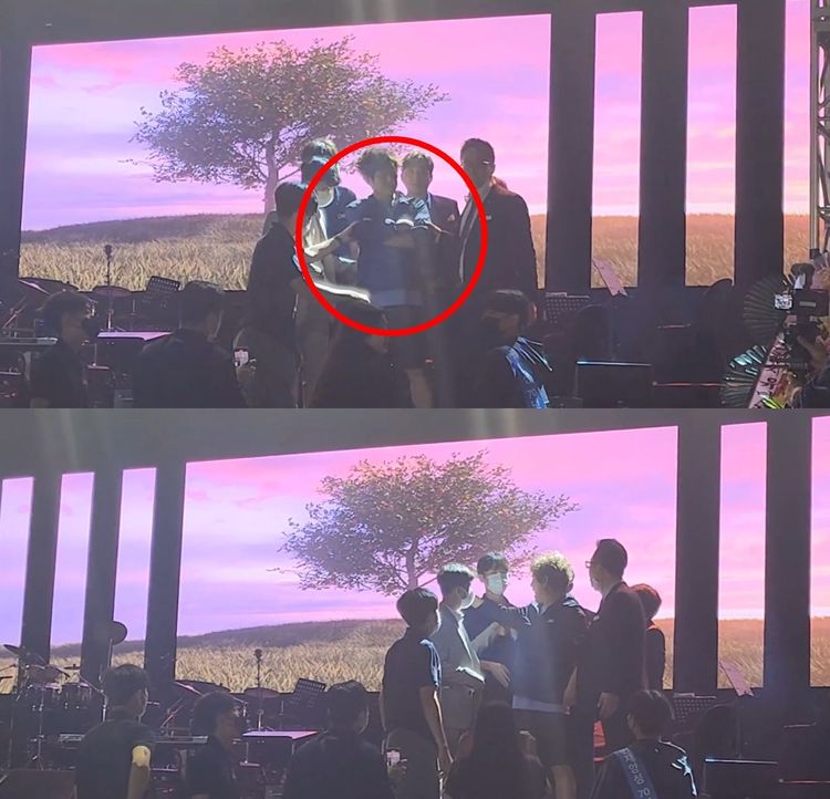 該名男子賴在台上，雙手抱胸爭論，還用手指向許閣的方向。翻攝YouTube