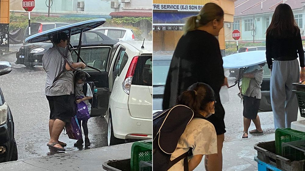 父親搬圓桌幫兒女遮雨。翻攝自「JB新山吹水站2.0」臉書